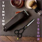 Black barber thinning scissors placed with haircut tools and accessories on table by Styleup Beauty Tools